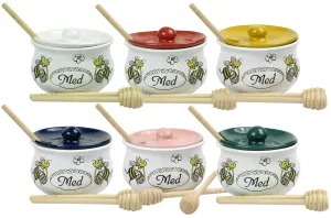 Nádoba na med s dřevěnou lžičkou.